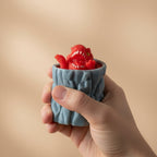 PopRex in hand — palm-sized scale